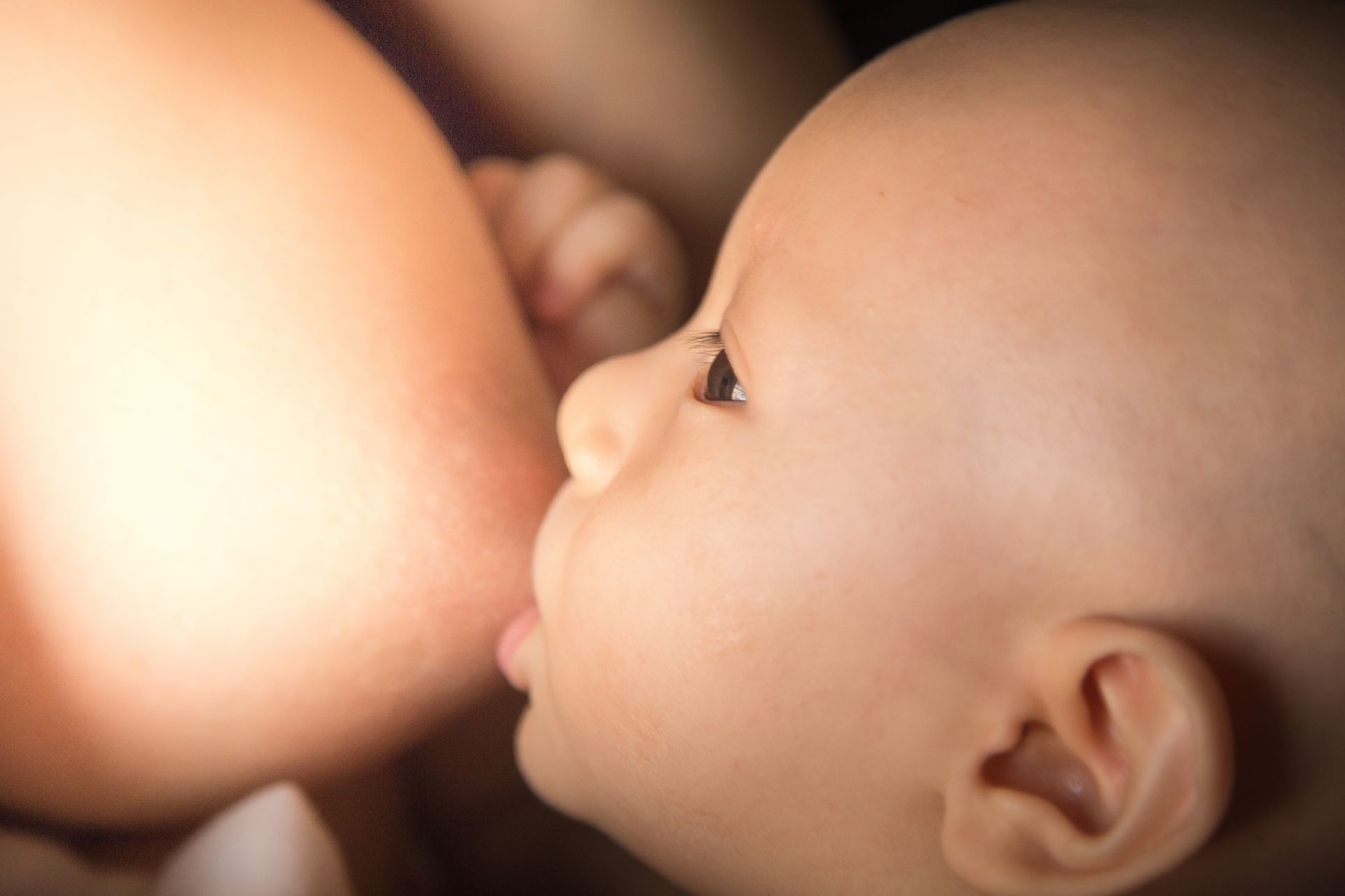 Close up Mother breastfeeding her newborn baby.